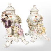 A pair of 20th century Dresden porcelain urns and covers on figural stands, height 31 cm.