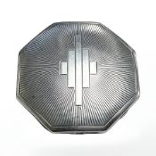 A silver engine turned powder compact.