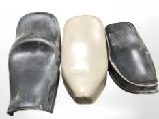 Three leather motorcycle seats