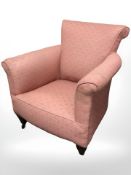 An Edwardian library armchair in the Howard style raised on brass castors,