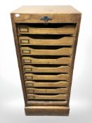 An early 20th century oak tambour front office index chest, 43 cm x 39 cm x 101 cm.
