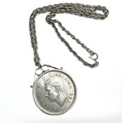 A silver chain and locket with 1937 silver crown.