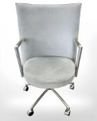 A Danish Erik Jorgensen designed Partner chrome framed executive swivel armchair in pale blue suede
