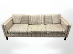 A late 20th century Danish three seater settee in checked fabric,