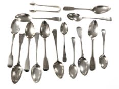 A group of Georgian and later silver teaspoons and a pair of sugar tongs.