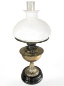 A Veritas brass oil lamp with opaque shade, height 55 cm.