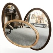 Three Edwardian oak oval mirrors, longest 82 cm.
