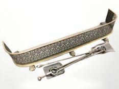A 19th century brass and steel fire curb on paw feet, width 117 cm, and a steel fire companion set.