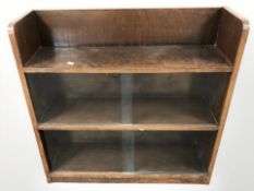 An early 20th century oak sliding glass door bookcase, width 76 cm.