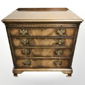 A good quality reproduction mahogany four drawer bachelor's chest in the George III style,