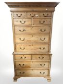 An early 20th century pine chest on chest in the George III style, fitted twelve drawers,