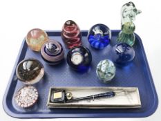A group of glass paperweights,