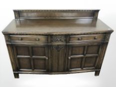 A reproduction oak linen fold sideboard, 139 cm x 53 cm x 99 cm.