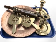 A copper charger, pair of brass chamber sticks, further pair of trivets and an Eastern carving set.