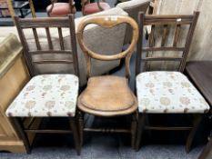 A pair of floral upholstered mahogany dining chairs and a further balloon back chair.