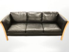 A late 20th century Danish wood framed black leather three seater settee,