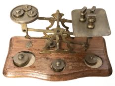 A set of Victorian oak and brass letter scales with graduated weights, width 24 cm.