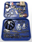 A collection of car badges, locking petrol cap, etc.