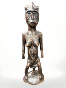 An African carved wooden fertility figure, height 72 cm.