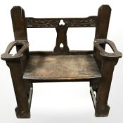 An Arts and Crafts carved oak hall seat incorporating two stick stands, 88 cm x 37 cm x 92 cm.