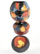 A Poole pottery vase, circular lidded trinket box and a further glazed pottery dish,