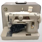 A Singer electric sewing machine with lead and pedal.
