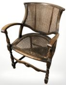 A beech bergere open armchair.