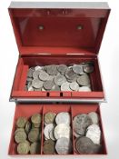 A tin of British pre-decimal coins.