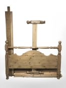 A contemporary pine 5' bed frame