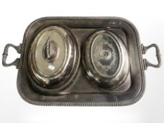 An EPNS twin handled serving platter, width 67 cm, a lidded entree dish and a further lid.