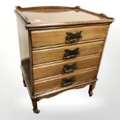 An Art Nouveau walnut four drawer music chest, width 49 cm.