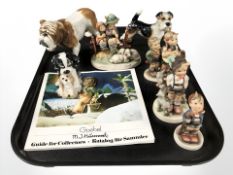 A group of Goebel figures of boys and girls, bulldog and two further dog ornaments.