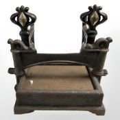 A pair of Art Nouveau cast iron and brass fire dogs, height 27 cm,