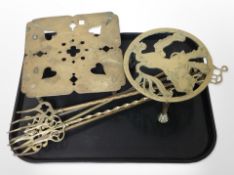 Two brass trivets and a group of toasting forks.