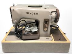 A Singer electric sewing machine, with lead and pedal.