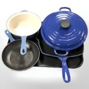 A Le Creuset enameled cast iron saucepan, skillet, a further pan and a twin handled lidded dish.