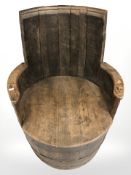 An oak barrel armchair,