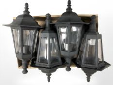 Four contemporary plastic outdoor wall lights.