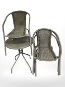 A circular patio table and four cane work chairs