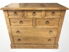 A contemporary oak seven drawer chest,