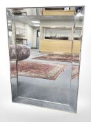 A contemporary frameless mirror 76 cm x 107 cm