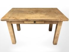 A contemporary oak dining table,