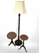 A reproduction standard lamp and two tripod tables.
