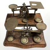 Two sets of Victorian oak and brass letter scales with weights.
