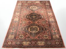 A machine made rug of Persian design,