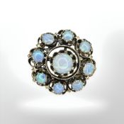 A 14ct gold opal ring, set with nine cabochon Australian opals weighing 5.02ct, size L.