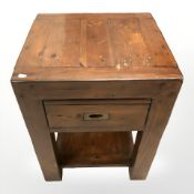 A stained pine lamp table fitted a drawer,