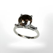 A platinum diamond solitaire ring, the cognac brown brilliant cut diamond weighing 3.