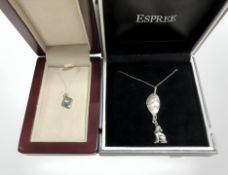 A silver and abalone pendant on chain, and a further silver howling wolf pendant on chain.