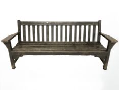 A stained teak garden bench,